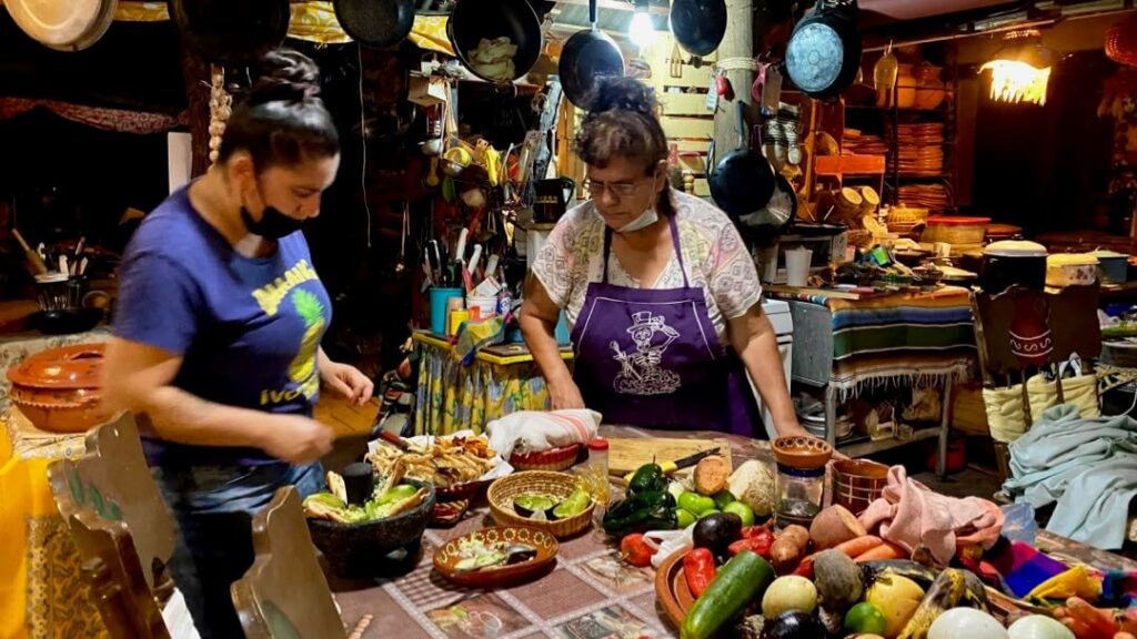 Sophia and cook preparing your tasting menu food in the museum-home style kitchen - Canipole - Art in Food in Loreto, Mexico