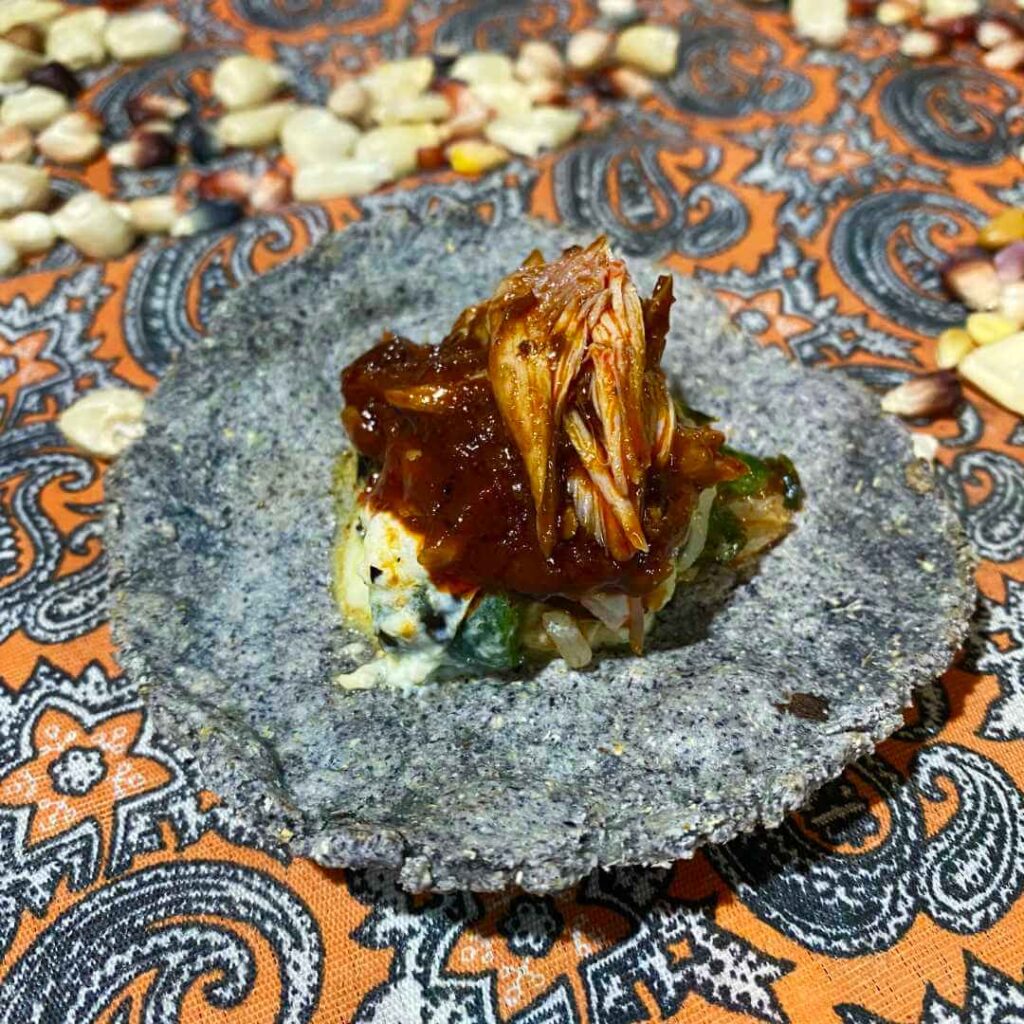 Bite size chicken tarte on handmade blue corn tortilla appetizer at Canipole - Art in Food in Loreto, Mexico