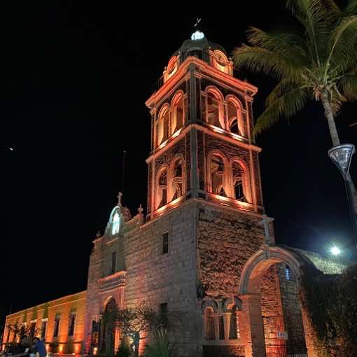 The Mission lit up at night in downtown Loreto