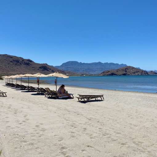 Private beach and loungers at the beach of Villa del Palmar in Loreto