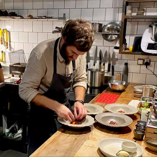 Lisbon's hidden gem restaurant Sem's chef George McLeod plating in the kitchen