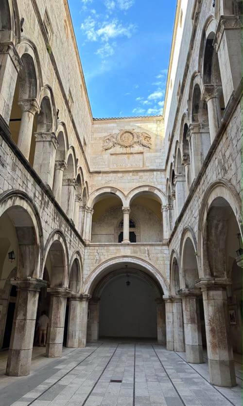 Inside Sponza Palace in Dubrovnik, Croatia, is Gothic-Renaissance style atrium surrounded by columns and arches