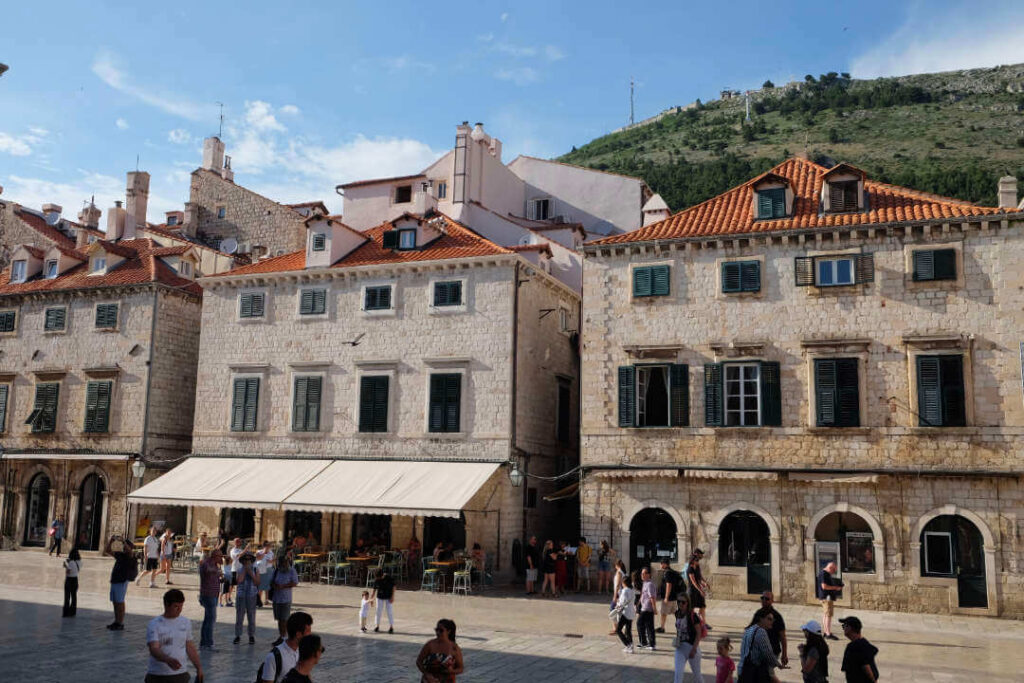 Buildings on Stradun street with mountain hillside in the background in Dubrovnik Old Town, Croatia