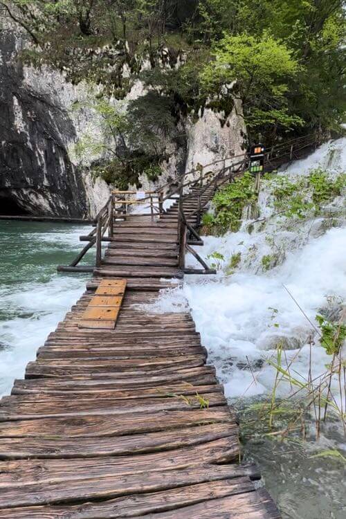 The rangers at Plitvice Lakes National Park, Croatia put wood plank over flooded boardwalk so people can walk on