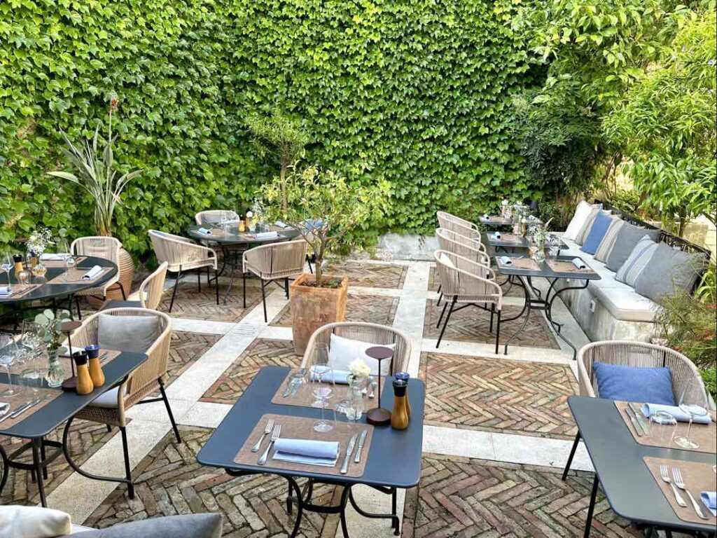 The elegant green secret garden outdoor seating area of Corte Restaurant, in Zadar, Croatia