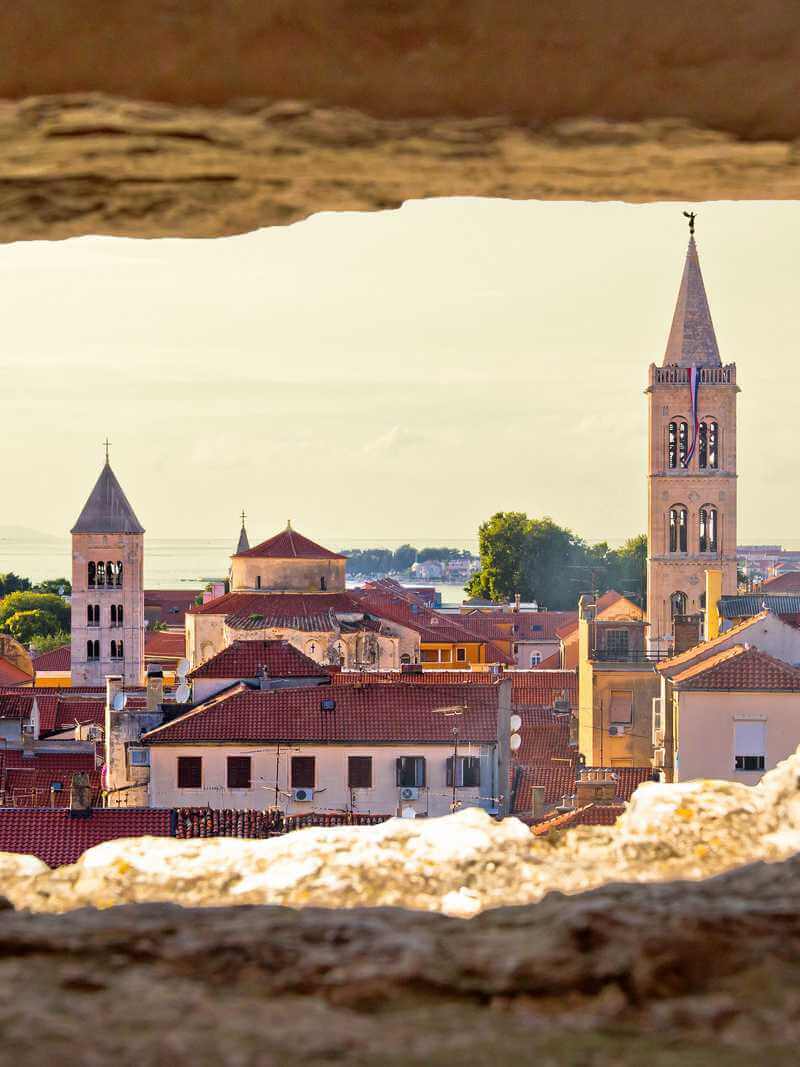 Aerial view of Zadar old town through a stone window, in Croatia