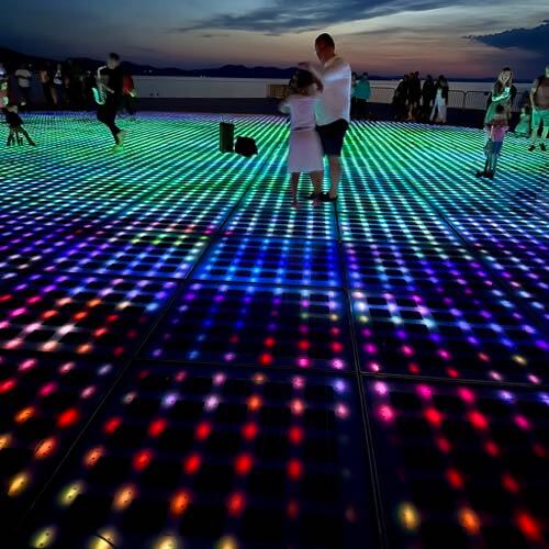 People dancing and playing to the live music and light show of the Monument to the Sun/Greeting to the Sun in Zadar, Croatia