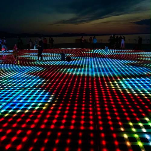 People enjoying the live music and constantly changing light show of the Monument to the Sun/Greeting to the Sun in Zadar, Croatia