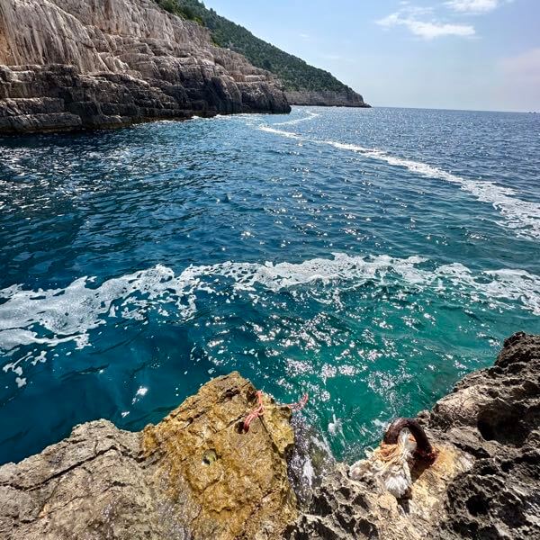 The sea entry point with a rope to Odysseus Cave on the island of Mljet in Croatia