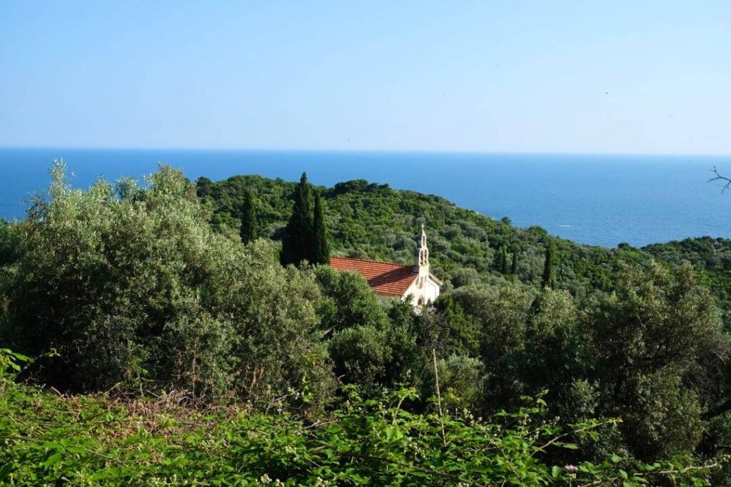 A chapel nested in the greenery on the island of Mljet in Croatia, with an ocean view