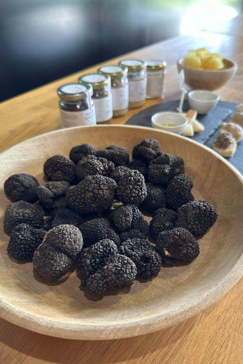 Truffle tasting at Pietro and Pietro in Istria Croatia, a basket filled with fresh black truffle, and preserved truffle, truffle cream
